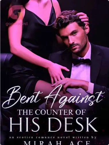Bent Against The Counter Of His Desk
